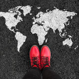 World map and woman in shoes