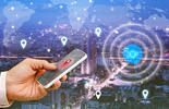 Hand holding mobile with city view mapping