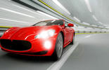 red sport car driving in tunnel