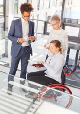Employees in the lobby and a person with disability
