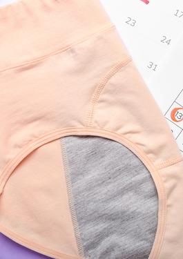 pink period underwear with a calendar used to track menstrual cycle