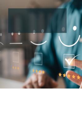 man at computer with different smiley faces representing customer reviews in front of the computer