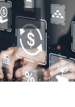 person working on computer with a variety of money and graph icons in front of the computer