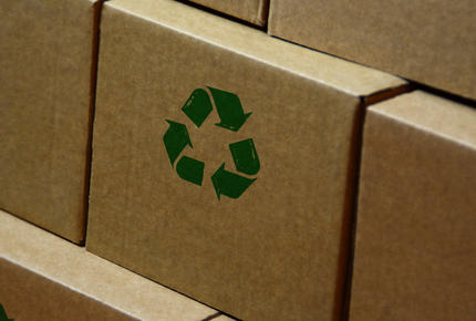 cardboard boxes with a green recycling symbol on it